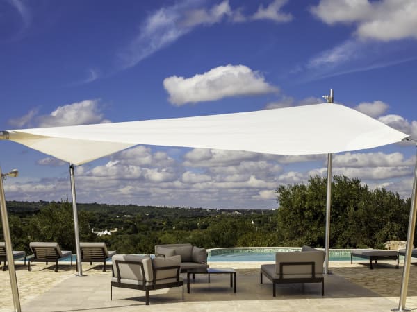 The shaded area between the first trullo and its pool.